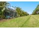 Landscaped backyard view of multiple villas and lush green space at 3922 Wildgrass Pl, Parrish, FL 34219