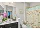 Small bathroom with dark vanity, starfish shower curtain at 3922 Wildgrass Pl, Parrish, FL 34219