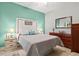 Guest bedroom with light walls, wood dresser, and ceiling fan at 3922 Wildgrass Pl, Parrish, FL 34219