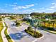 Landscaped entrance to a residential community with guard house and palm trees at 3922 Wildgrass Pl, Parrish, FL 34219