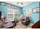 Home office with light blue walls, wood desk, and seating at 3922 Wildgrass Pl, Parrish, FL 34219