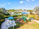 Community playground with play structures and shaded seating at 3922 Wildgrass Pl, Parrish, FL 34219