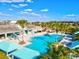 Resort-style pool with lounge chairs, palm trees, and shaded areas at 3922 Wildgrass Pl, Parrish, FL 34219