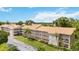 Aerial view of an apartment building complex with a pool and lush landscaping at 3987 Maceachen Blvd # 123, Sarasota, FL 34233