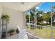 Relaxing enclosed patio overlooking a lush green landscape and pool at 3987 Maceachen Blvd # 123, Sarasota, FL 34233