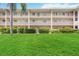 Condo building with lush landscaping and a manicured lawn at 3987 Maceachen Blvd # 123, Sarasota, FL 34233