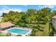 Community pool with surrounding patio and lush greenery at 3987 Maceachen Blvd # 123, Sarasota, FL 34233