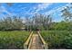 Private wooden dock with a boat lift at 4027 Siren Rd, Venice, FL 34293