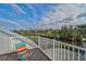 Relaxing deck with scenic views of the water and lush greenery at 4027 Siren Rd, Venice, FL 34293