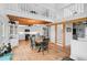 Open concept dining area with wooden floors and exposed beams at 4027 Siren Rd, Venice, FL 34293