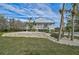 White cottage style home with a metal roof and stone landscaping at 4027 Siren Rd, Venice, FL 34293