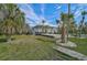 Home with walkway leading to porch and tropical landscaping at 4027 Siren Rd, Venice, FL 34293