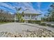 House with metal roof, porch, and manicured lawn at 4027 Siren Rd, Venice, FL 34293