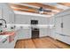 Modern kitchen with exposed beams, copper sink, and wooden floors at 4027 Siren Rd, Venice, FL 34293