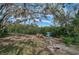 Serene waterfront view with benches under shade trees at 4027 Siren Rd, Venice, FL 34293