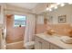 Bathroom with pink tile, bathtub and updated vanity at 418 Sarabay Rd, Osprey, FL 34229