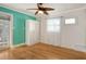 Bedroom with teal accent wall and hardwood floors at 418 Sarabay Rd, Osprey, FL 34229