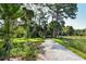 Landscaped garden path winds through lush foliage, creating a serene outdoor space at 418 Sarabay Rd, Osprey, FL 34229