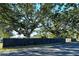 Modern black fence and large oak trees at 418 Sarabay Rd, Osprey, FL 34229