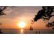 Peaceful sunset view over the water with sailboat at 418 Sarabay Rd, Osprey, FL 34229