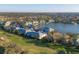 Aerial view of community with lake, golf course, and numerous homes at 4202 Caddie E Dr # 102, Bradenton, FL 34203