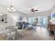 Light and airy dining area with a glass-top table and chandelier at 4202 Caddie E Dr # 102, Bradenton, FL 34203