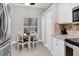 Kitchen breakfast nook with white cabinets and wood table at 4202 Caddie E Dr # 102, Bradenton, FL 34203