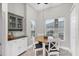 Kitchen breakfast nook with white cabinets and wood table at 4202 Caddie E Dr # 102, Bradenton, FL 34203