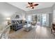 Bright living room with sliding glass doors leading to a screened patio at 4202 Caddie E Dr # 102, Bradenton, FL 34203