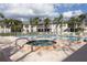 Resort-style pool and spa with surrounding lounge chairs at 4202 Caddie E Dr # 102, Bradenton, FL 34203