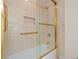 Clean bathroom with a shower/tub combo and gold accents at 4512 Spring Flower Ct, Sarasota, FL 34233