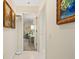 Bright hallway with access to bedrooms and art pieces on the wall at 4512 Spring Flower Ct, Sarasota, FL 34233