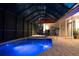 Inviting pool and patio at night with lighting at 4512 Spring Flower Ct, Sarasota, FL 34233