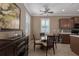 Bright dining area with glass table and four chairs, adjacent to kitchen at 4608 Halls Mill Xing, Ellenton, FL 34222