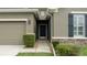 House entrance with dark door and landscaping at 4608 Halls Mill Xing, Ellenton, FL 34222