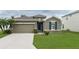 One-story house with green lawn and attached garage at 4608 Halls Mill Xing, Ellenton, FL 34222