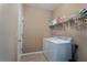 Bright laundry room, washer, dryer, and ample shelving at 4608 Halls Mill Xing, Ellenton, FL 34222