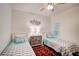 Guest bedroom with twin beds, wood accents, and plantation shutters at 4826 Maymont Park Cir, Bradenton, FL 34203