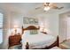 Main bedroom with king-size bed, wood furniture, and plantation shutters at 4826 Maymont Park Cir, Bradenton, FL 34203