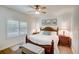 Main bedroom with king-size bed, wood furniture, and plantation shutters at 4826 Maymont Park Cir, Bradenton, FL 34203