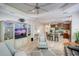 Open living room features built-in shelving, hardwood floors, and an adjacent kitchen at 4826 Maymont Park Cir, Bradenton, FL 34203