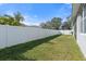 Private backyard with grassy area and white vinyl fence at 5007 Elmhurst Ln, Palmetto, FL 34221