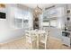 Bright breakfast nook with white table and chairs, and view to backyard at 5007 Elmhurst Ln, Palmetto, FL 34221