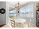 Charming breakfast nook with white table and chairs near sliding glass door at 5007 Elmhurst Ln, Palmetto, FL 34221