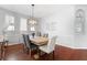 Dining room with wooden table and gray chairs, hardwood floors at 5007 Elmhurst Ln, Palmetto, FL 34221