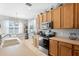 Spacious kitchen with stainless steel appliances and light wood cabinets at 5007 Elmhurst Ln, Palmetto, FL 34221