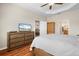 Main bedroom with dresser, large bed, and view into bathroom at 5007 Elmhurst Ln, Palmetto, FL 34221