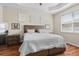 Main bedroom with light wood dresser and large bed at 5007 Elmhurst Ln, Palmetto, FL 34221