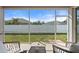 Relaxing screened porch overlooking backyard with seating at 5007 Elmhurst Ln, Palmetto, FL 34221