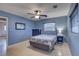 Blue bedroom with a double bed and ceiling fan at 5117 6Th Avenue W Dr, Bradenton, FL 34209